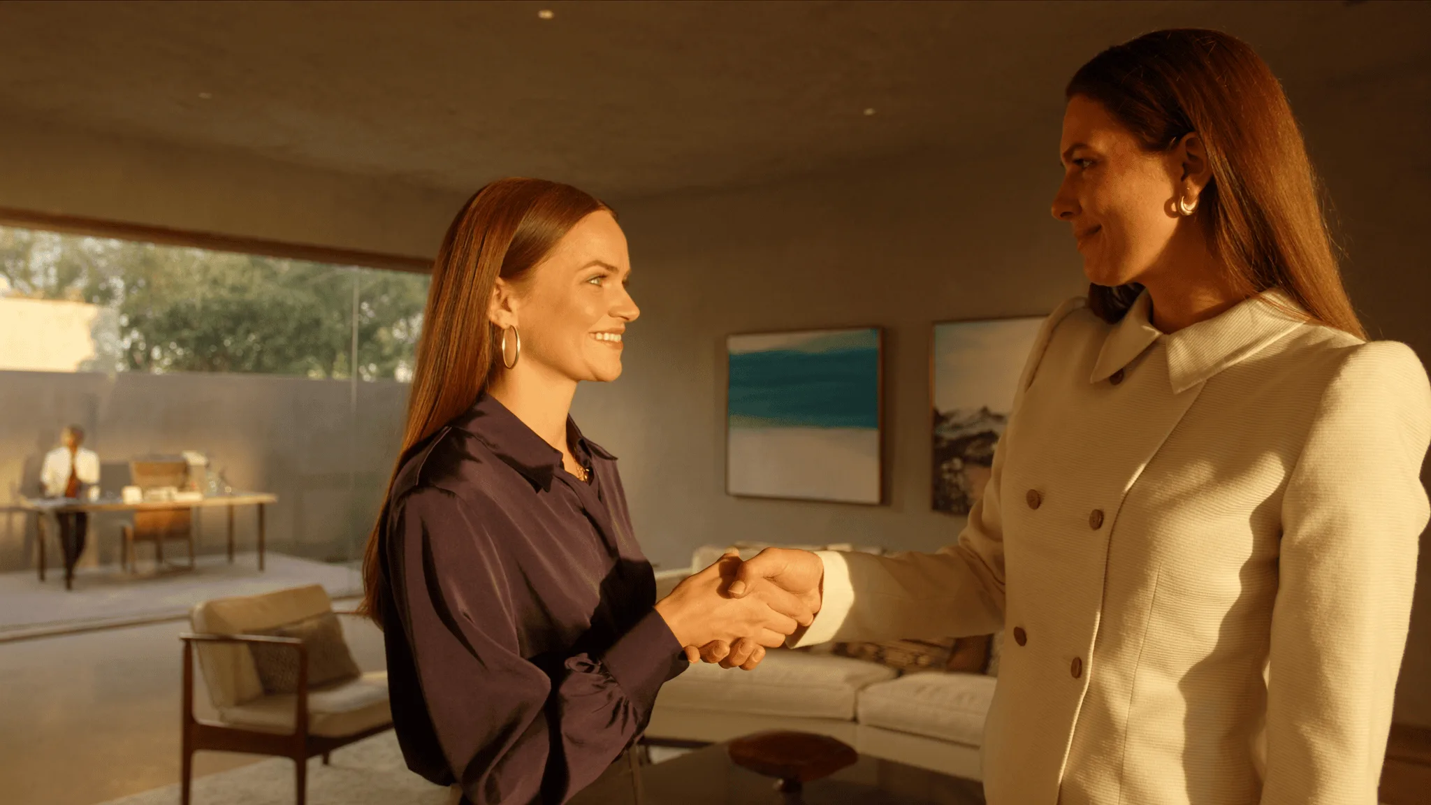 A young woman mid-handshake offering an alliance to a peer with mutual recognition.